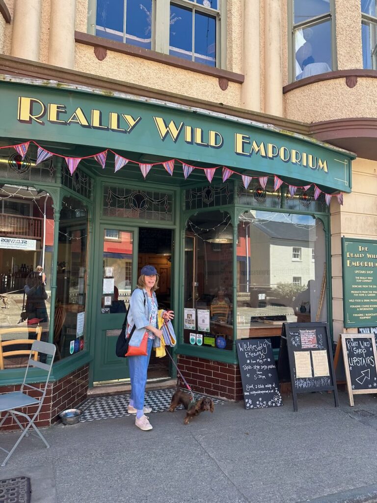 Lady with dachshund in doorway of Really Wild Emporium