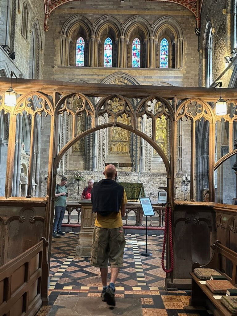 Man in shorts walking into central nave of Cathedral